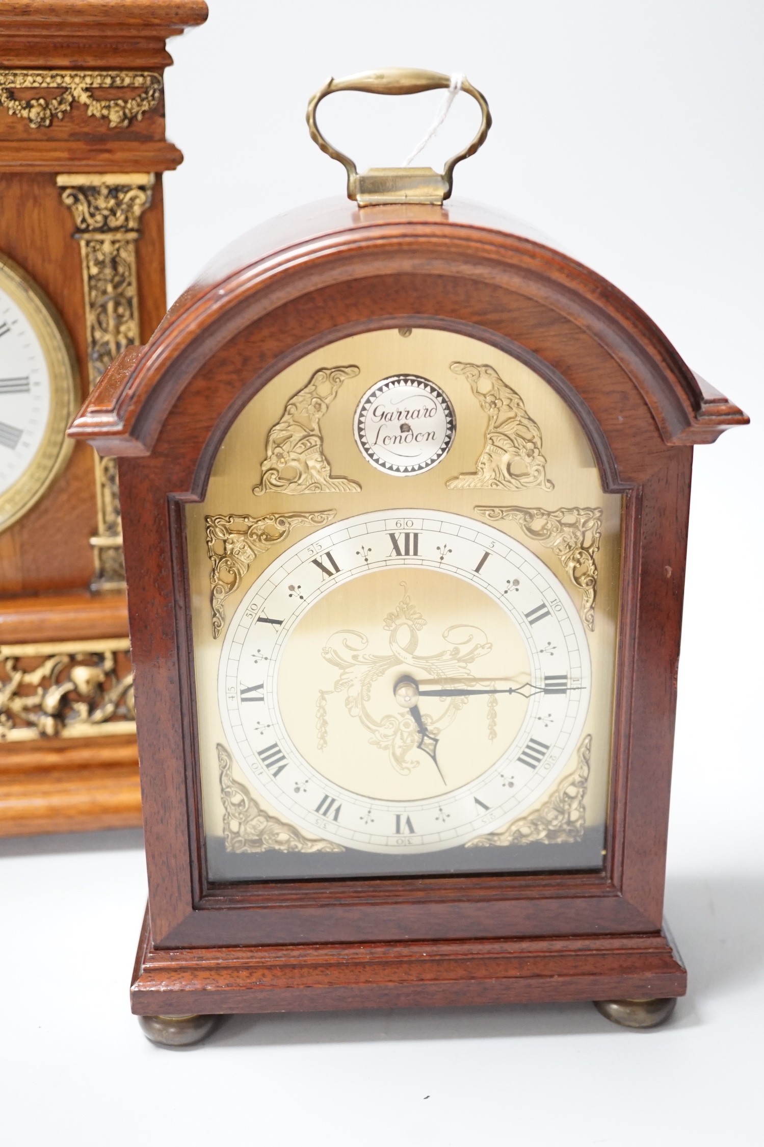 A Garrard clock and an oak brass mounted clock 29cms high